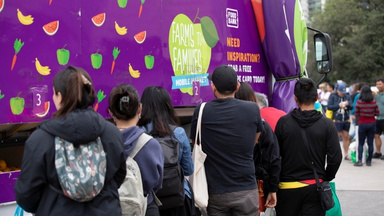 People queuing at the FoodBank Farms to families mobile market truck