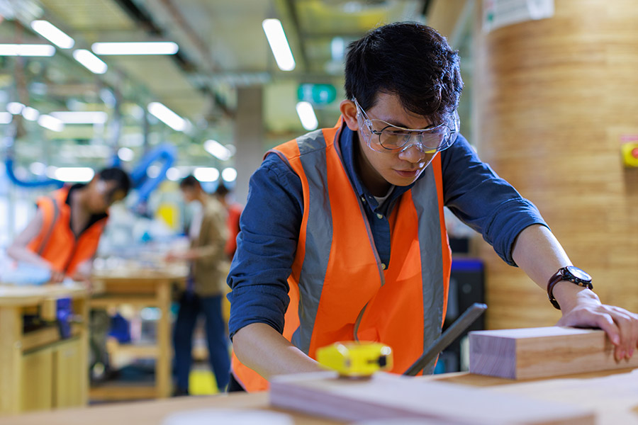 Student in safety gear during woodwork class