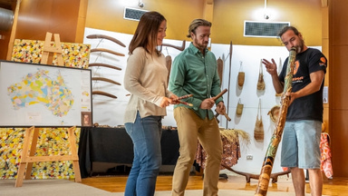 First nations person sharing aboriginal artifacts and map of languages