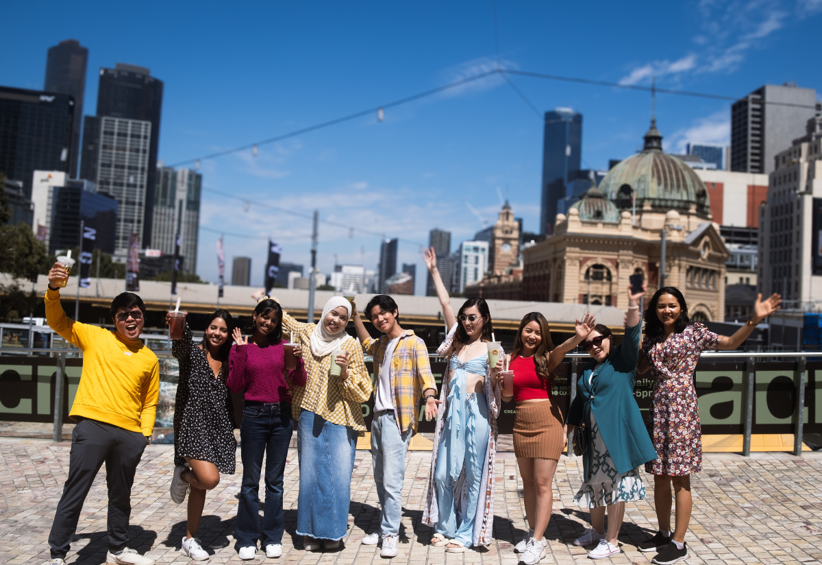 a group of people posing for a photo at Fed Square