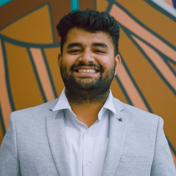 Head shot of Akiho, aboriginal art in background