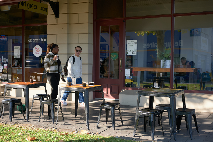 2 people walking down a cafe