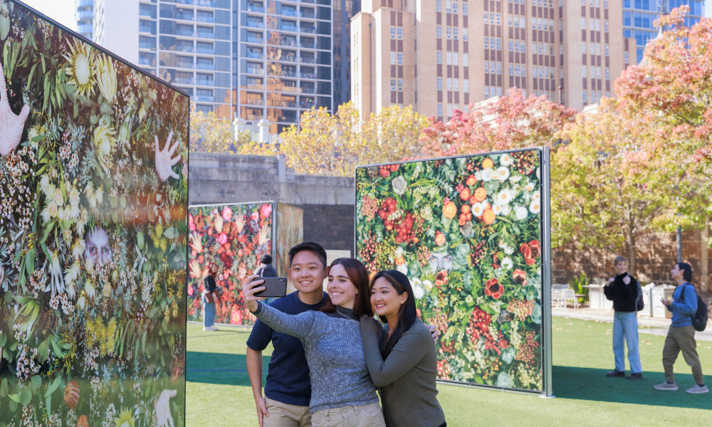 Three students together and taking a photo